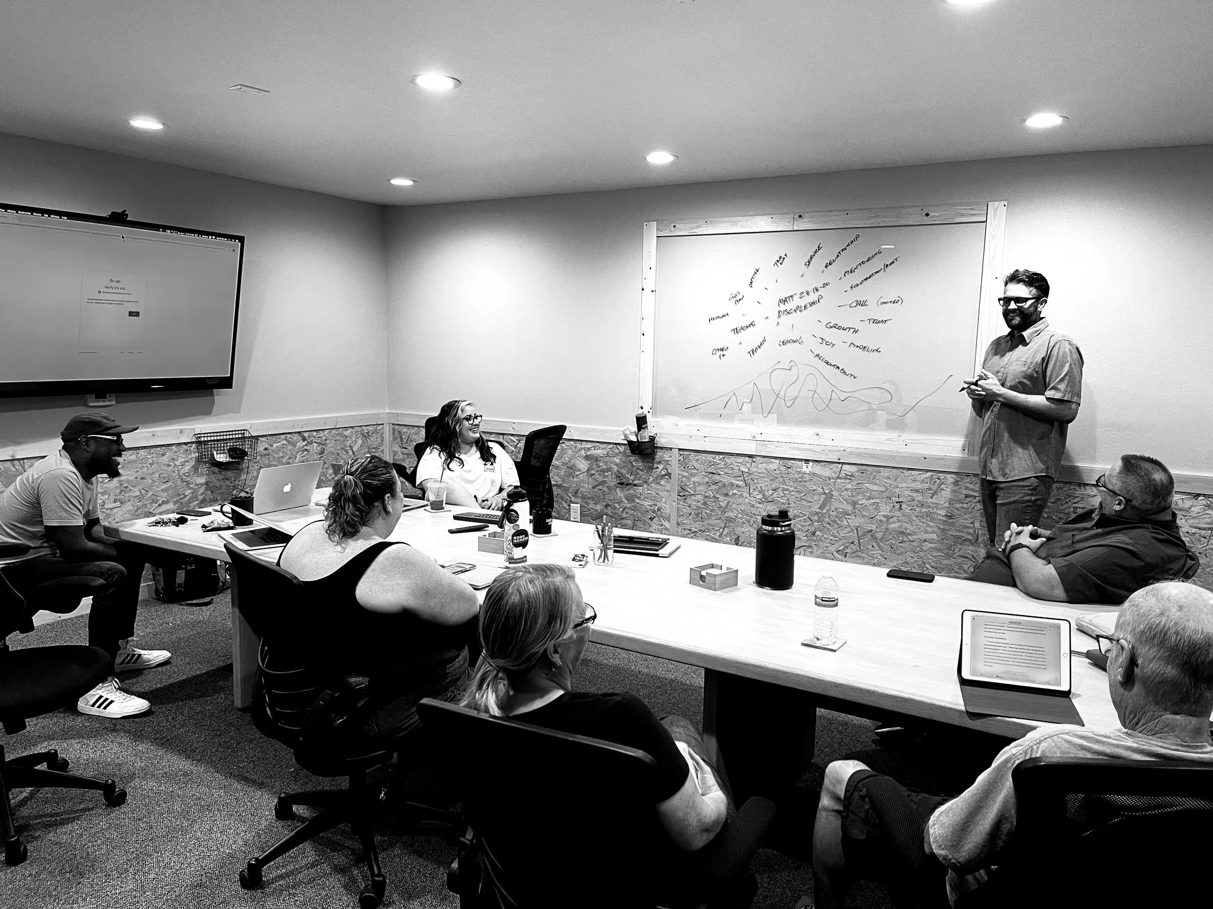 Chris Reinhard facilitating a leadership team discussion at a whiteboard